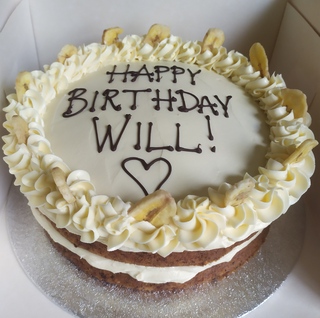 Vegan banana cake with vanilla buttercream, message piped on top
